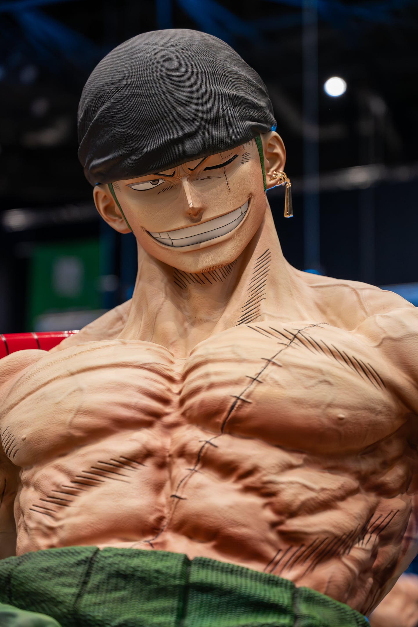 Close-up of a grinning character display wearing a black bandana.