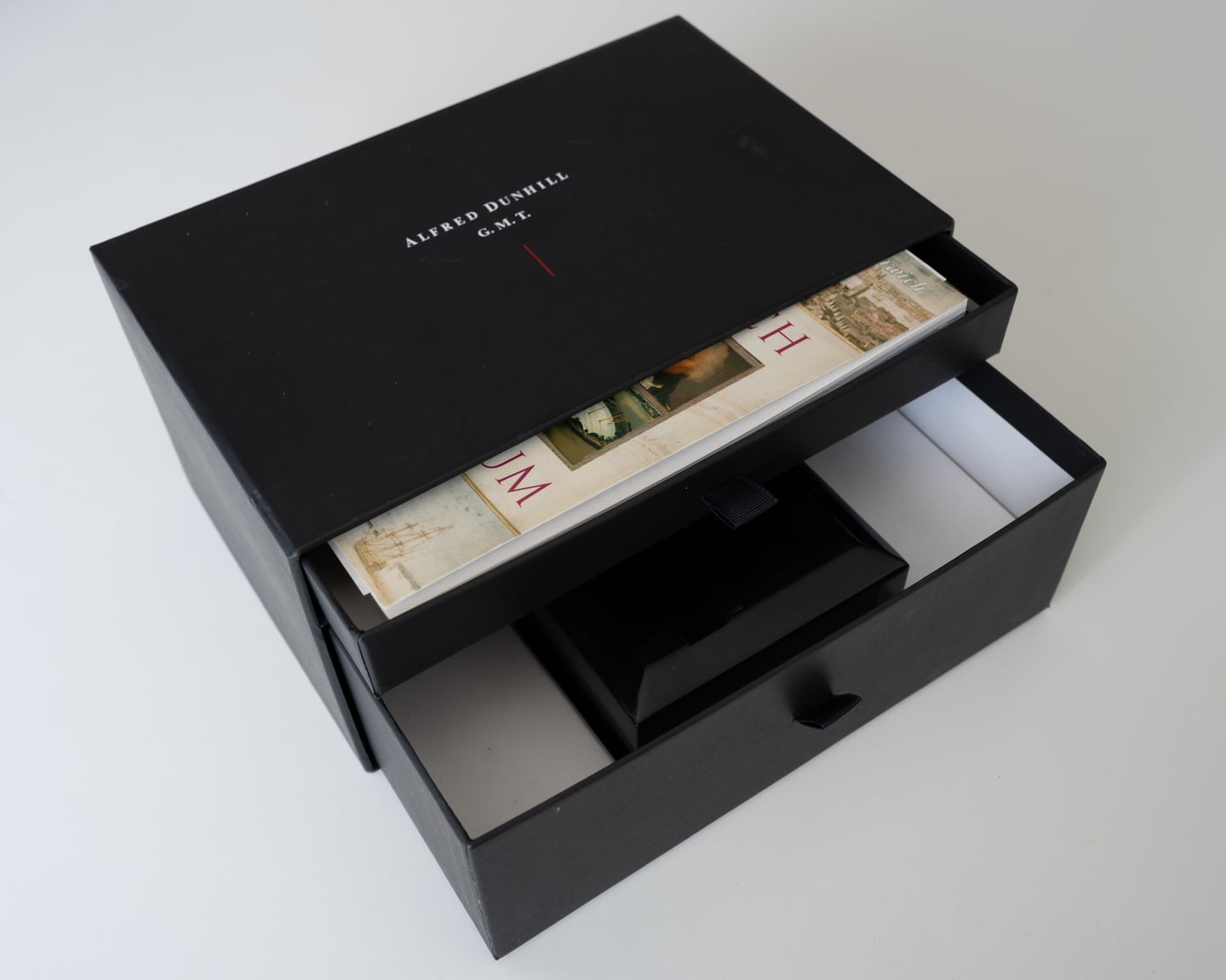 A black presentation box with its compartments open.